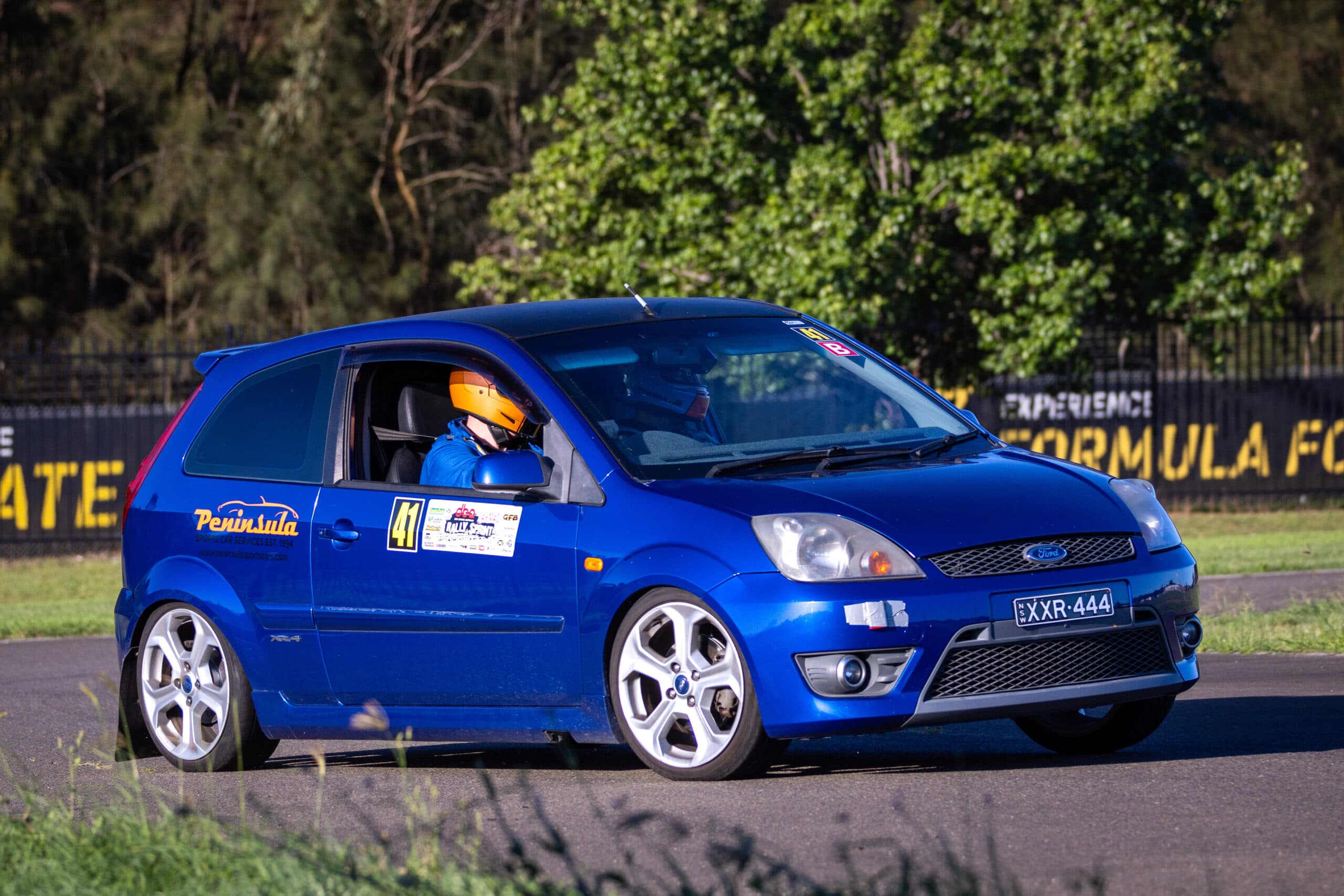 A road car cornering hard at a Tarmac Sprint Series round